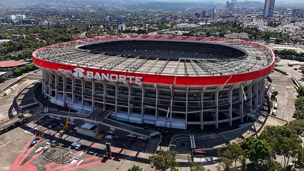 Aerial view of the Estadio Azteca bowl amid Mexico City's sprawl.