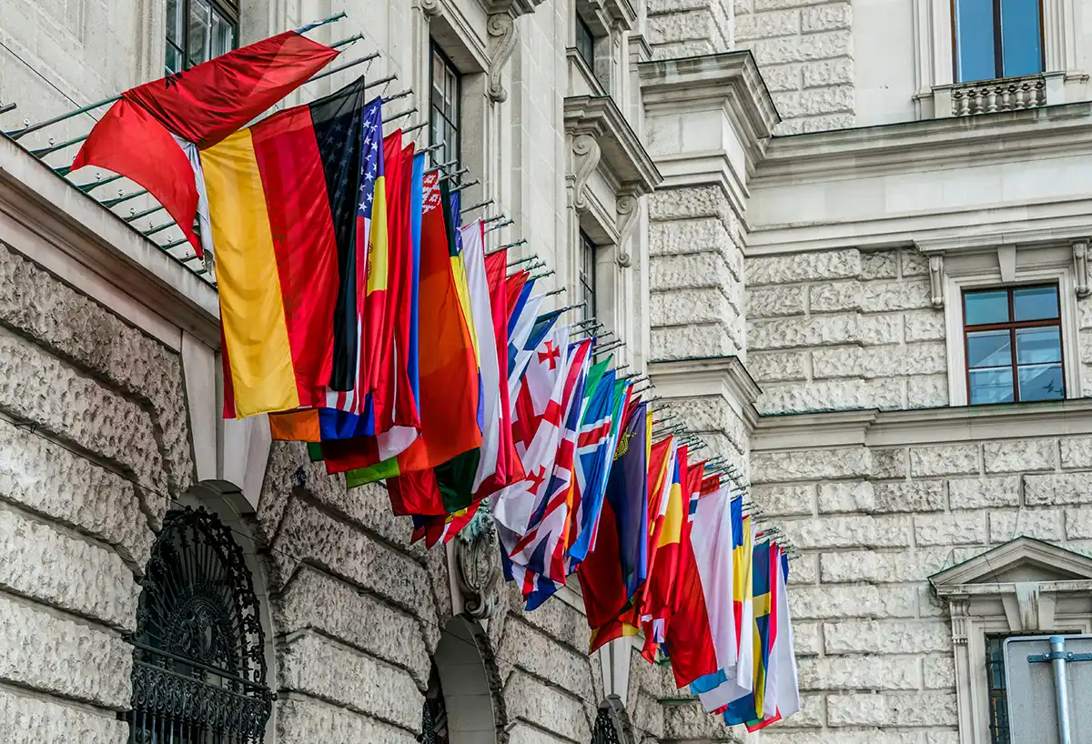 Rows of member-state flags outside the OSCE headquarters in Vienna.