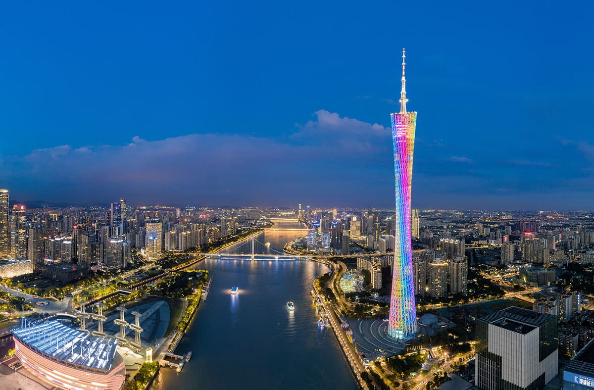 Guangzhou's skyline along the Pearl River at dusk.