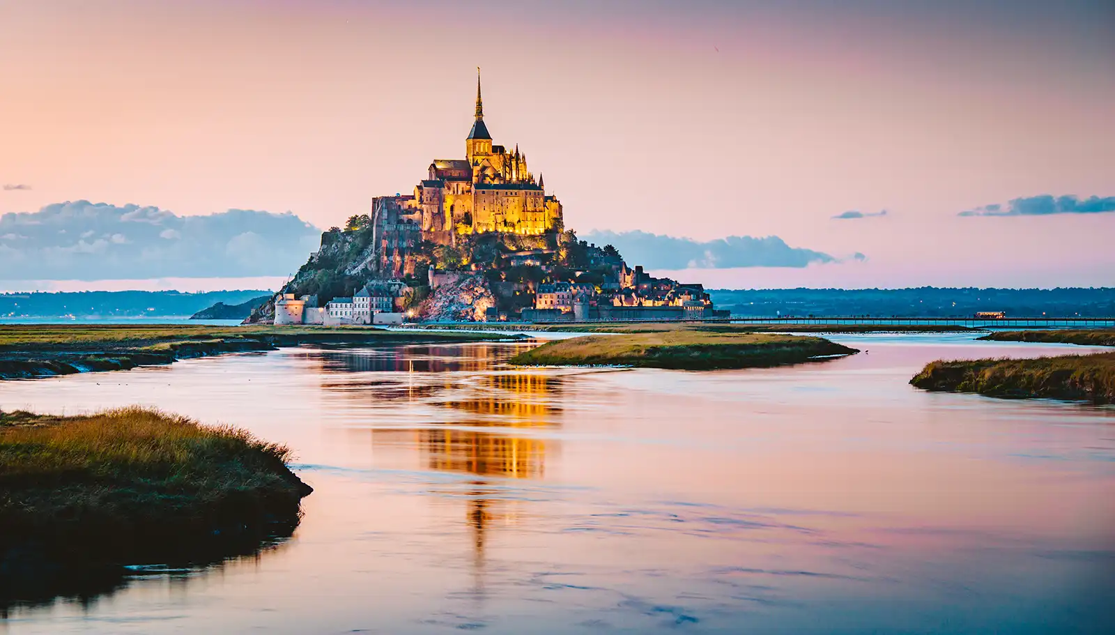 Mont-Saint-Michel and its abbey rising from tidal flats off the Normandy coast.