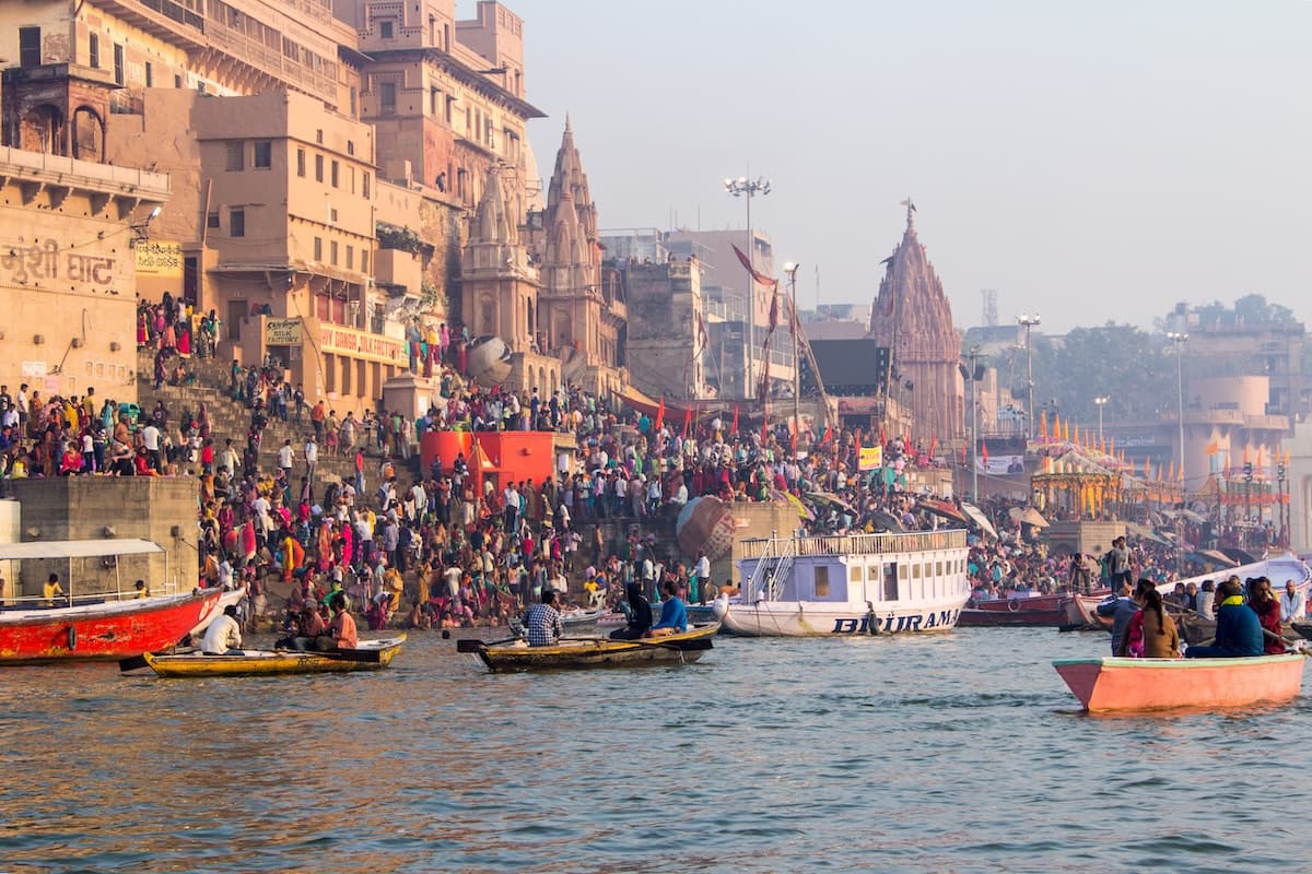 Varanasi's ghats lit with oil lamps for Diwali along the Ganges at dusk.
