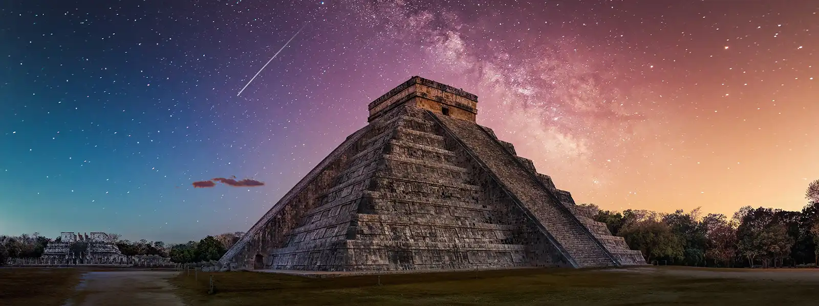 The stepped pyramid of El Castillo at Chichén Itzá under a blue sky.