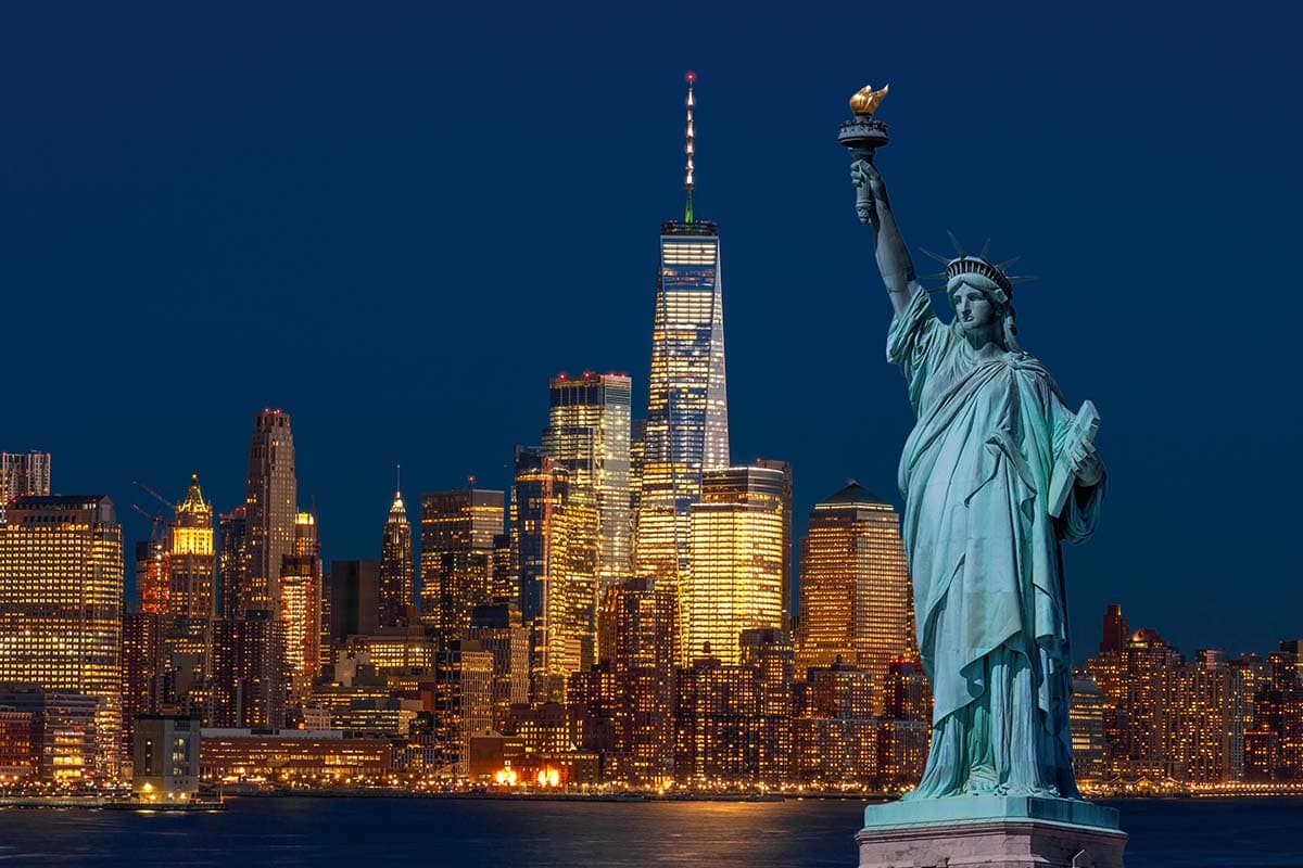 The Statue of Liberty with the Manhattan skyline behind it.